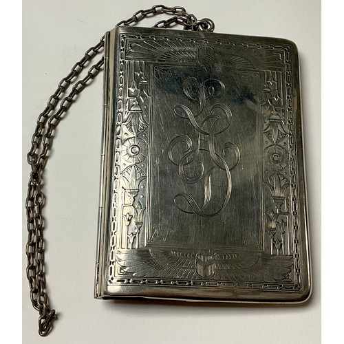 534 - An early 20th century Egyptian revival sterling silver rounded rectangular purse, engine turned with... 