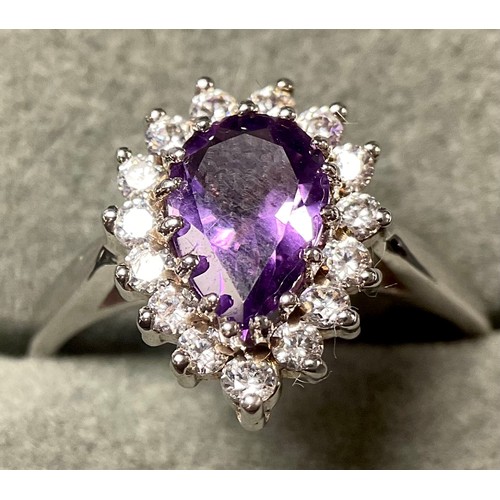 642 - A 9ct white gold ring, the central pear cut amethyst surrounded by brilliant cut cubic zirconia, siz... 