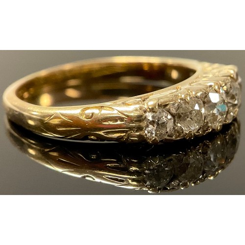 646 - An unmarked gold five stone diamond ring, the graduated old cut stones interspersed with diamond chi... 