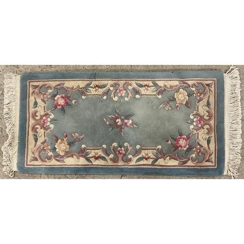 407 - A Chinese woollen rug, with stylised flowers and scrolls on a grey ground, 128cm long, 62cm wide