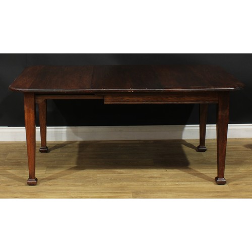 501 - A late Arts & Crafts period oak extending dining table, 68cm high, 104.5cm extending to 150.5cm long... 