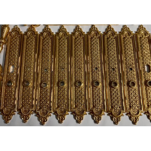 685 - Interior Furnishings - a set of five gilt metal door plates, cast with trellis and flowerheads, 38.5... 