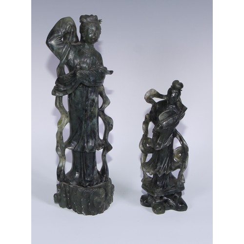 67A - A Chinese carved jade figure, of a courtesan holding a rabbit, 29cm high; another, holding a fan, 20... 