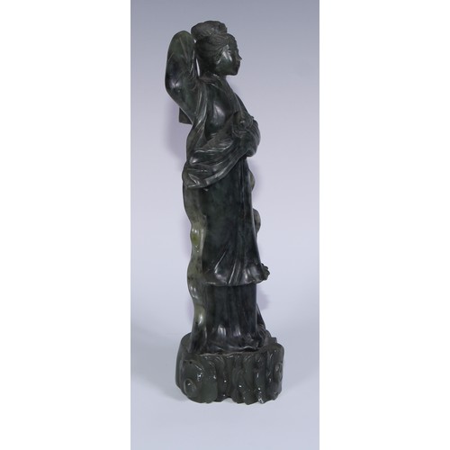 67A - A Chinese carved jade figure, of a courtesan holding a rabbit, 29cm high; another, holding a fan, 20... 