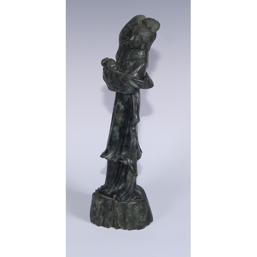 67A - A Chinese carved jade figure, of a courtesan holding a rabbit, 29cm high; another, holding a fan, 20... 