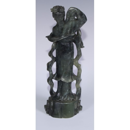 67A - A Chinese carved jade figure, of a courtesan holding a rabbit, 29cm high; another, holding a fan, 20... 