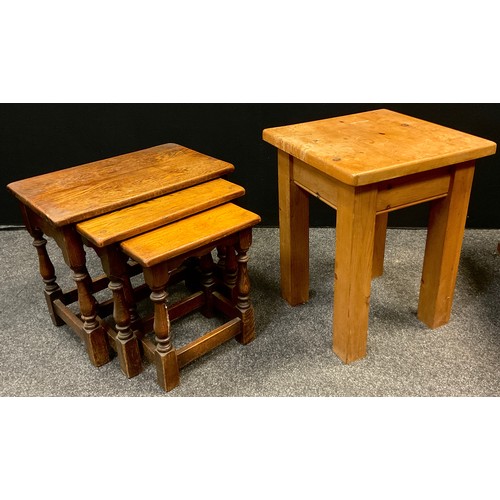 59 - A mid 20th century oak nest of three tables, turned legs, the largest measuring 48cm tall x 55cm x 3... 