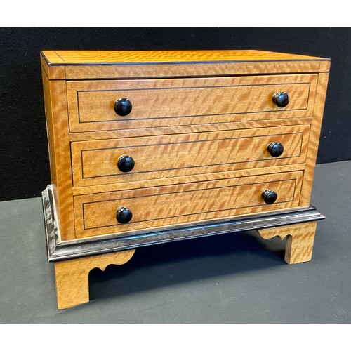 74 - A satinwood miniature chest, three long drawers, bracket feet, 33cm high, 39cm high