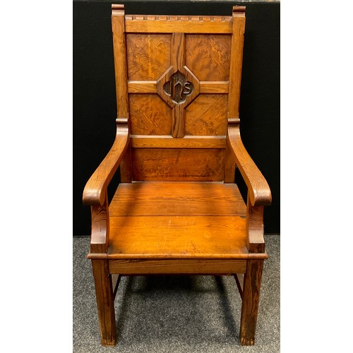 93 - A mid 20th century Pitch pine Wainscot chair, four-panel back, carved plaque to centre with initials... 