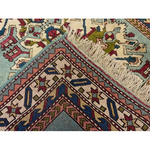 119 - A Chelaberd or ‘Eagle Kazak’ style rug, knotted in subtle tones of blue, cream, earthy green, and re... 