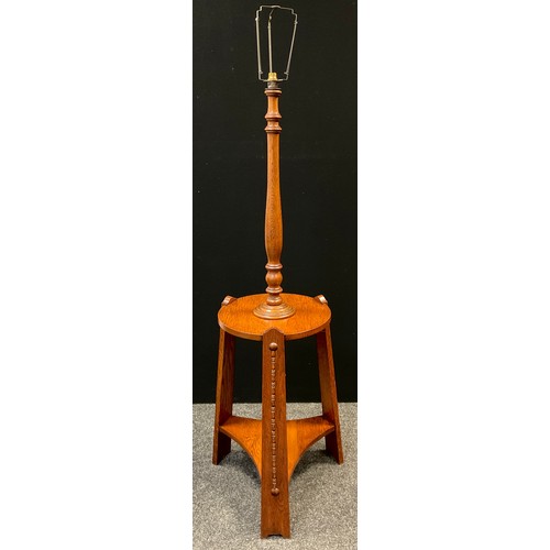 125 - An Arts and Crafts oak table standard-lamp, turned lamp column to top, circular tripod table base, 1... 