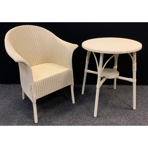 127 - A Lloyd Loom conservatory armchair, and conforming circular side table, each with labels, 72cm tall ... 