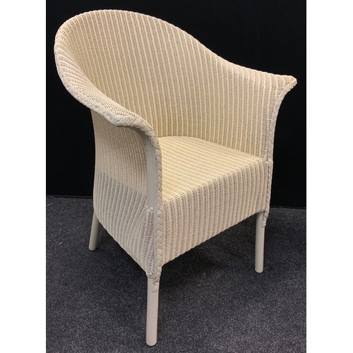 127 - A Lloyd Loom conservatory armchair, and conforming circular side table, each with labels, 72cm tall ... 