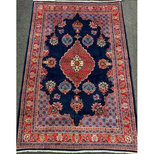 141 - A Hamadan rug / carpet, hand-knotted in rich blue, red, white, and pale blue, 318cm x 212cm.