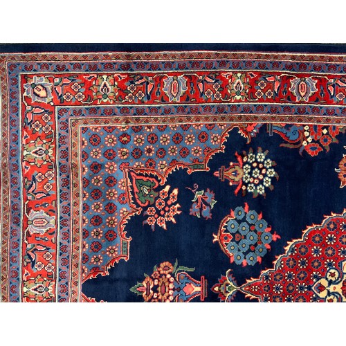 141 - A Hamadan rug / carpet, hand-knotted in rich blue, red, white, and pale blue, 318cm x 212cm.