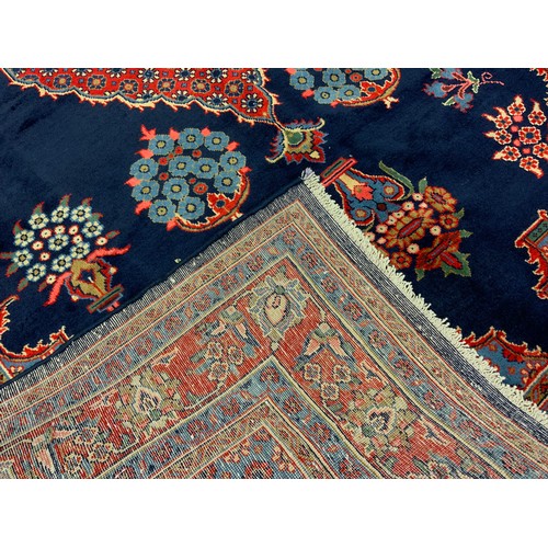 141 - A Hamadan rug / carpet, hand-knotted in rich blue, red, white, and pale blue, 318cm x 212cm.