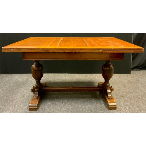 143 - A mid 20th century oak draw-leaf trestle dining table, 77.5cm tall x 98.5cm wide x 133cm long (211cm... 