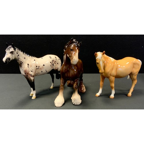 163 - A Beswick model, Appaloosa horse;  others Swish tail; Royal Doulton Cantering Shire (3)