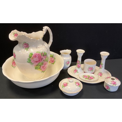 175 - A 20th century Morley Fox & Co ten piece dressing table set, decorated with pink roses inc washing j... 