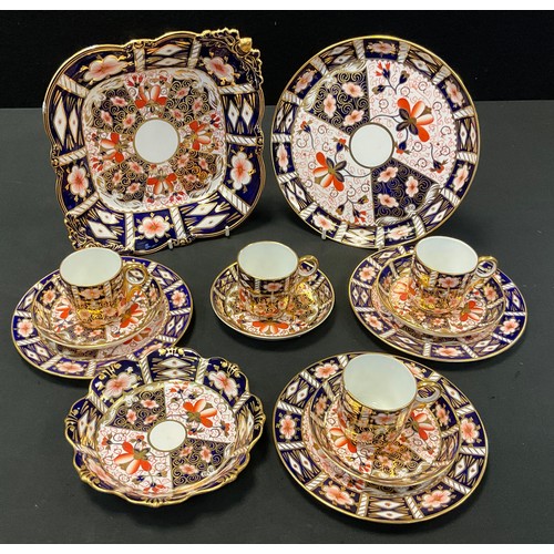 180 - A set of four Royal Crown Derby 2451 pattern coffee cups, saucers and side plates, printed marks, da... 