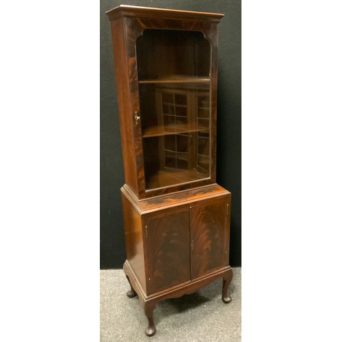 291 - A narrow mahogany book case cabinet, single door glazed top enclosing two shelves, above two door cu... 