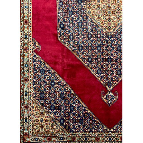 310 - A Bijar rug / carpet, hand-knotted with a large central hexagonal shaped medallion in a rich red fie... 