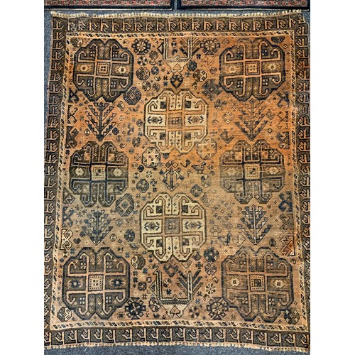 312 - An early to mid 20th century Afghan style rug, hand-knotted with stylised motifs in earthy tones, 15... 