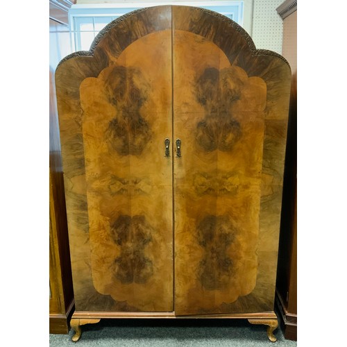 317 - An Art Deco walnut cloud top two door wardrobe, 194cm high, 123cm wide, 50cm deep