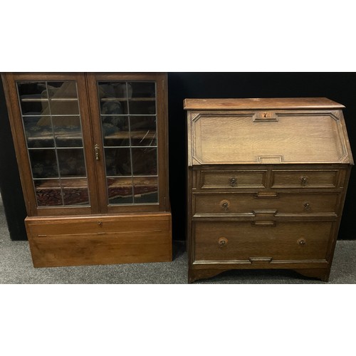 314 - An early 20th century oak bureau bookcase (the top converted for use as a stand alone cabinet with a... 