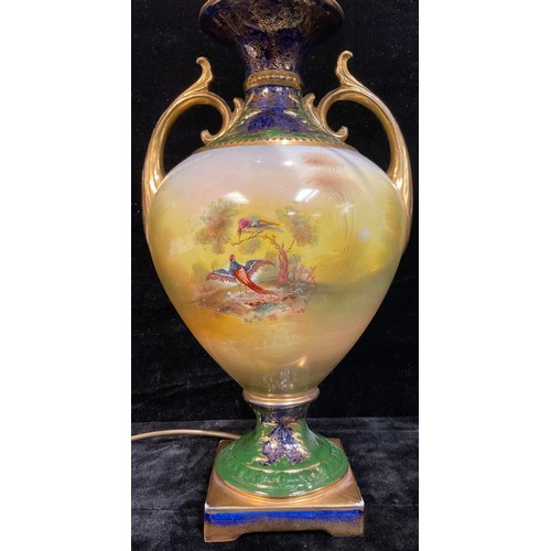 206 - A Staffordshire table lamp, printed and painted with fanciful birds perched and in flight, gilt scro... 