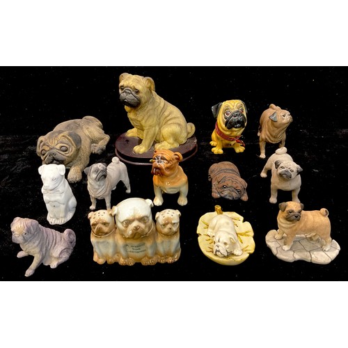 475 - An early 20th century novelty three pug dog cruet set, A Present From Caernarvon; other model pug do... 