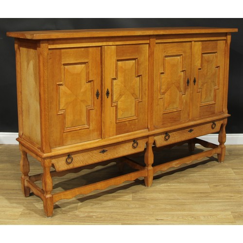 101 - A contemporary Spanish Baroque inspired oak side cabinet, 126.5cm high, 196.5cm wide, 49cm deep