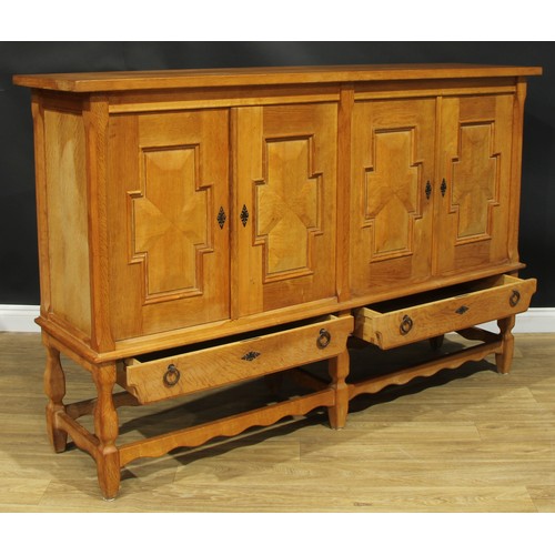 101 - A contemporary Spanish Baroque inspired oak side cabinet, 126.5cm high, 196.5cm wide, 49cm deep