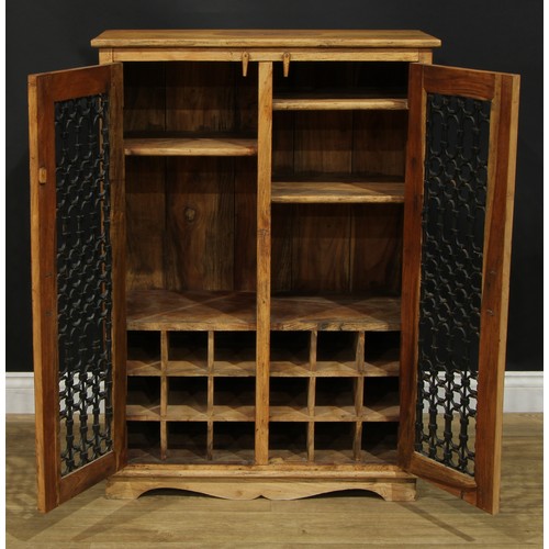 106 - A contemporary mango oenophilist’s provision cupboard, rectangular top above a pair of doors enclosi... 