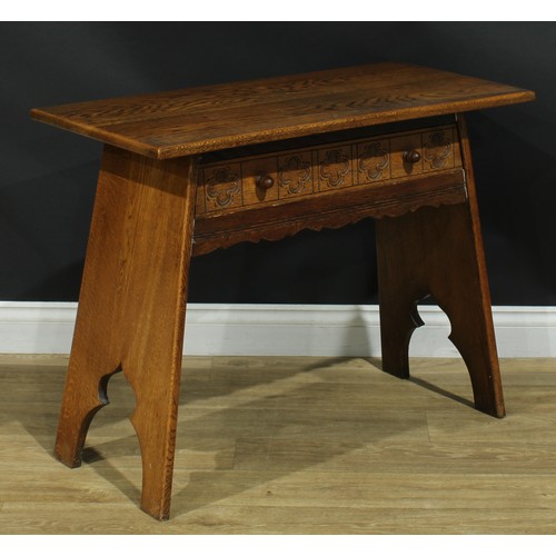 116 - An Arts & Crafts style oak side table, oversailing rectangular top above a long frieze drawer, 69.5c... 