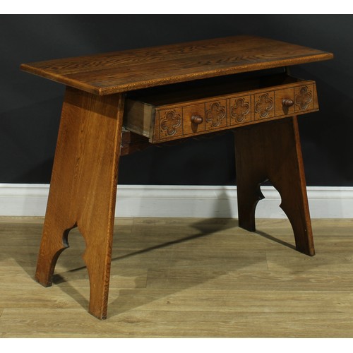 116 - An Arts & Crafts style oak side table, oversailing rectangular top above a long frieze drawer, 69.5c... 