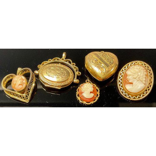 538 - A 9ct gold oval swivel locket, marked 375, 3.8g; two 9ct gold mounted shell cameo pendants, each mar... 