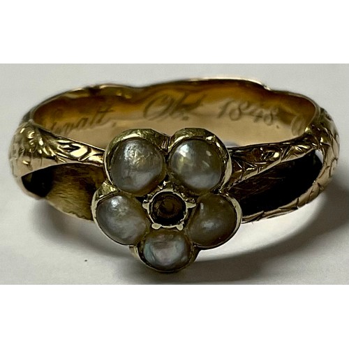 551 - A 19th century unmarked gold mourning ring, set with a five stone seed pearl flowerhead, the interio... 