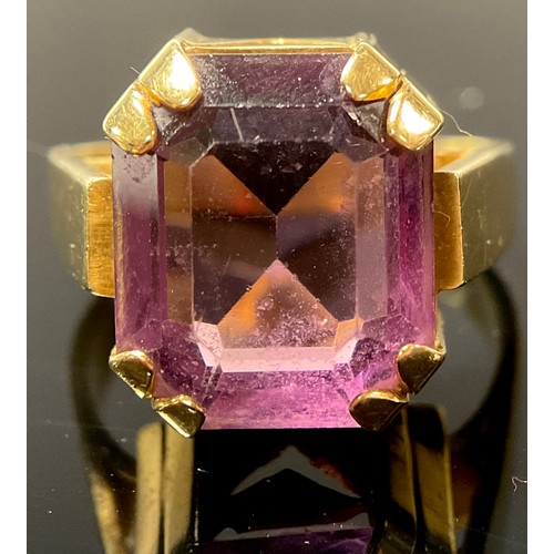 553 - An 18ct and palladium gold ring, set with a single faceted amethyst, size O, marked 18CTPALL, 10.8g