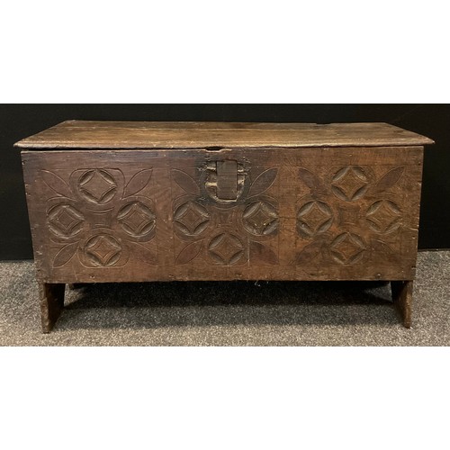 149 - An 18th century  six plank chest, the front carved with roundels and leaves,  48cm high, 95cm wide, ... 