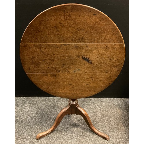 137 - A George III oak circular occasional table, tilting on  turned baluster-form column, cabriole legs, ... 