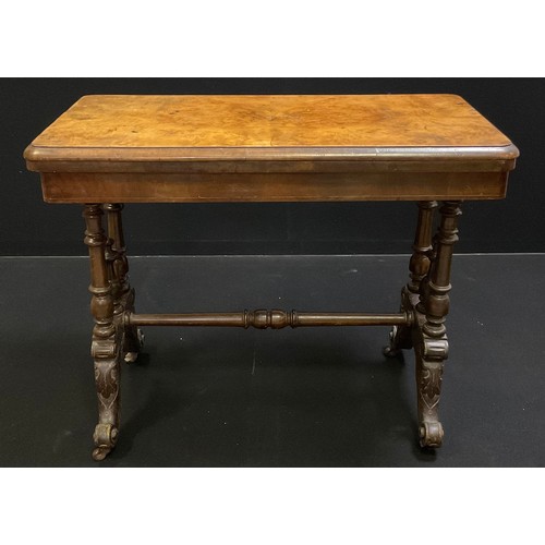 132 - A Victorian walnut and burr walnut card table, rounded rectangular top, turned supports, ceramic cas... 