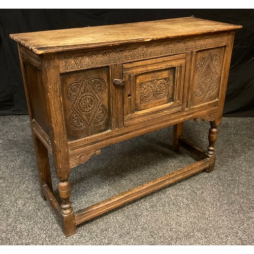 127 - A 18th century style carved oak small sideboard, oversailing top, single cupboard door to front, car... 