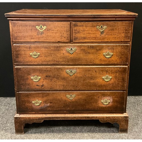 115 - A George III oak chest,  of two short over three long drawers, brass swan-neck handles, bracket feet... 