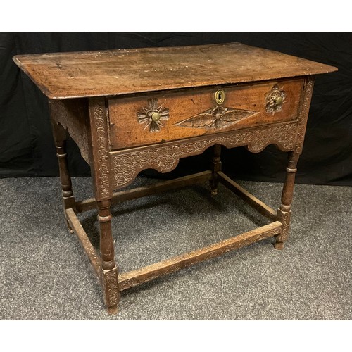 163 - An 18th century oak lowboy,  rounded rectangular over-sailing top,   turned supports, later carved, ... 