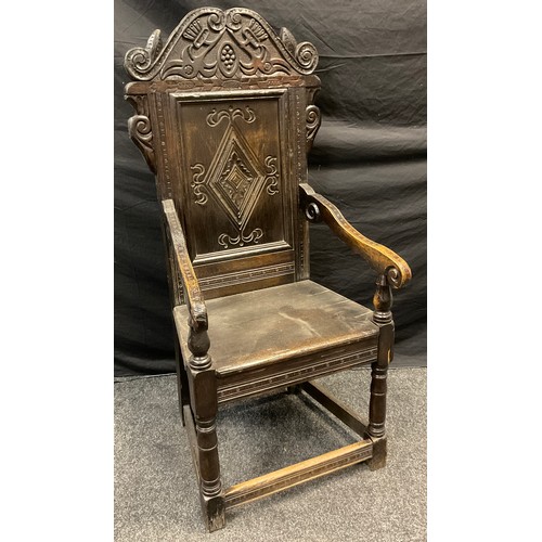 164 - An 17th century style  Wainscot chair, the back carved with scrolls and lozenge, scroll arms, solid ... 