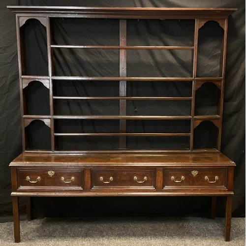 169 - A George III oak dresser and open plate rack, moulded cornice, moulded cornice,, the base with three... 