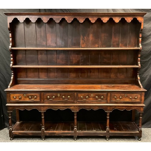 217 - A George III Oak Welsh Potboard Dresser, two tier plate rack top, over four short drawers, turned su... 