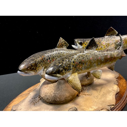 24 - A Peter Lowerson sculpture, Three Trouts, signed, dated 1997, 24.5cm high, 44cm long, oval plinth