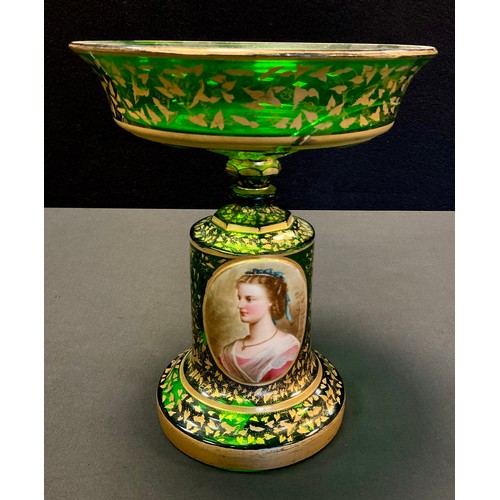 213 - A Bohemian emerald green glass comport, the cylindrical stand with painted oval portrait, decorated ... 